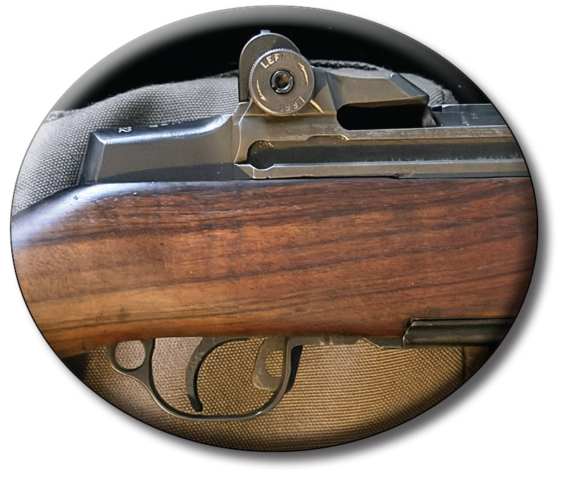 Side view of the M1 Garand shows the rear sight adjustment for windage and the trigger assembly with the safety engaged.